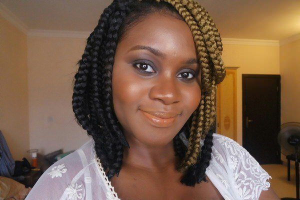 Box braids with side swept bangs for round face shape