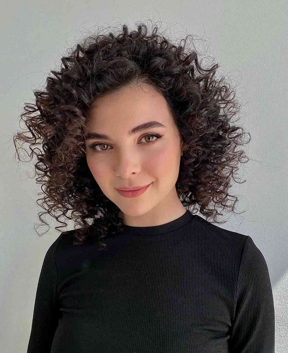 remarkable-frizzy-curls-on-a-bob-cut-with-a-long-curly-bang | CutAfrik Afro