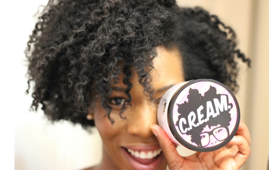 Image showing a woman with curling products for type 4 natural hair